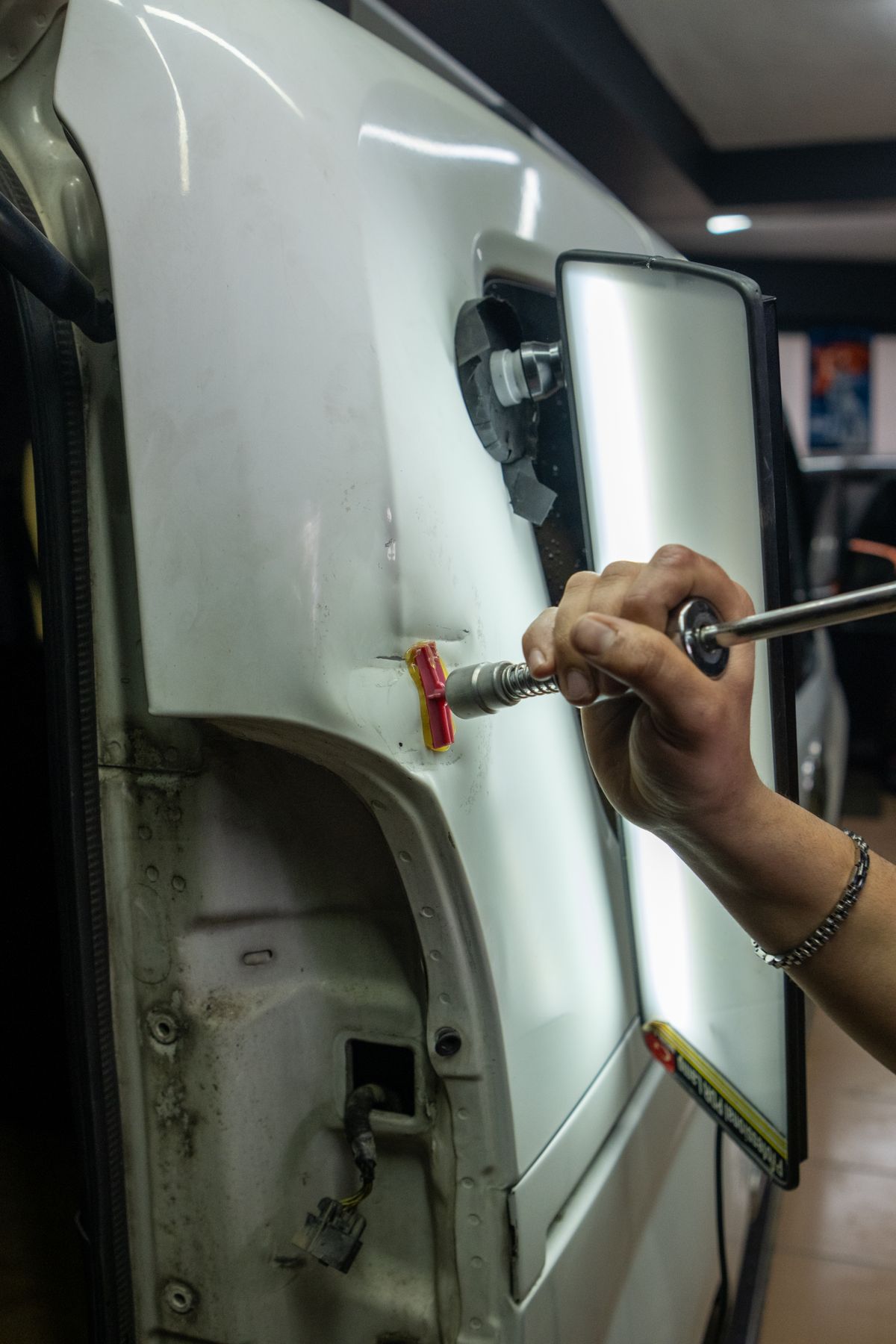 Close-up of precision dent repair on a vehicle panel