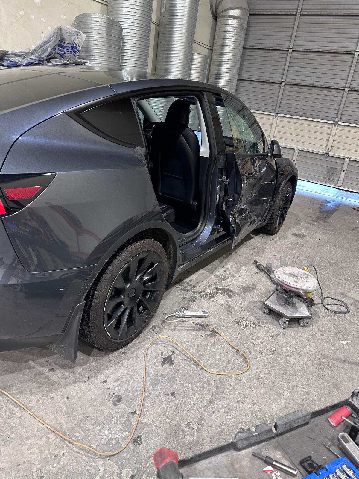 Grey SUV with severe side-door collision damage