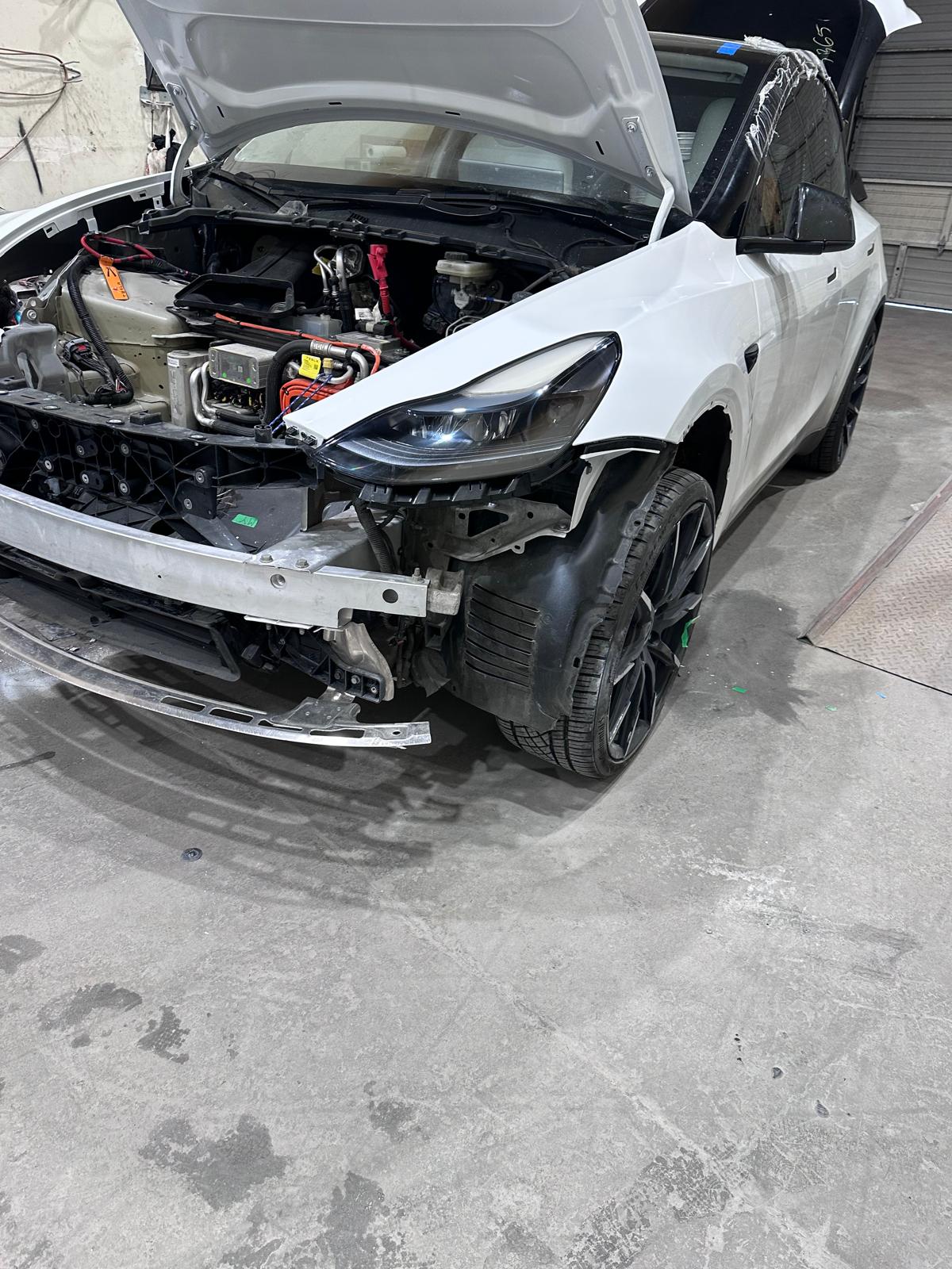 White SUV during front-end collision repair